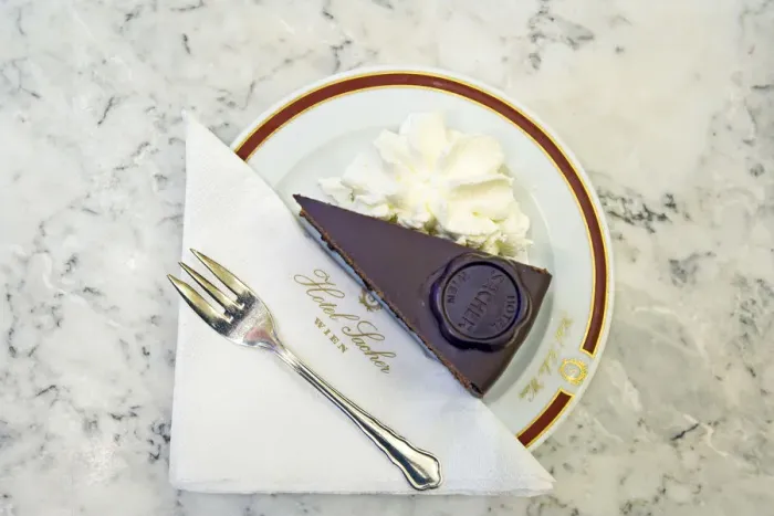 Framed Print : A slice of Original Sacher - Torte cake with whipped cream at Hotel Sacher, Vienna