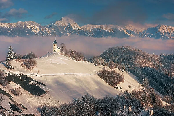 Slovenia, Jamnik, Church of St. Primoz with the Kamnik-Savinja Alps beyond, Gorenjska