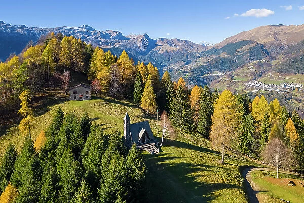 small Alpini church of Azzone and the Presolana massif in autumn. Azzone, Scalve valley, Bergamo province, Lombardy, Italy
