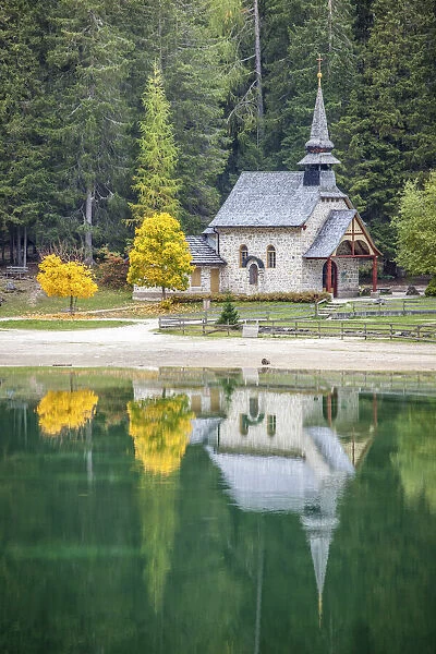 Small chapel on Lake Braies in autumn, South Tyrol, Italy