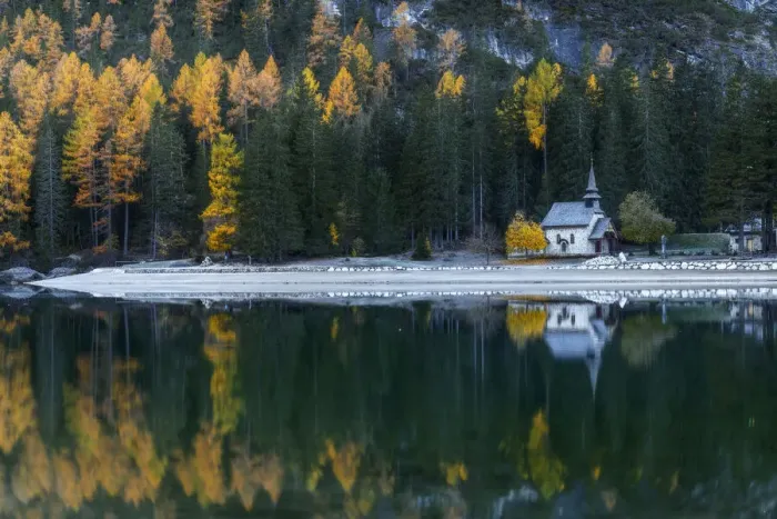 Framed Print : The small chapel on the shores of the Braies lake (Pragser Wildsee) with larches and firs reflecting in the lake. Dolomites, Italy Framed Print : The small chapel on the shores of the Braies lake (Pragser Wildsee) with larches and firs reflecting in the lake. Dolomites, Italy
