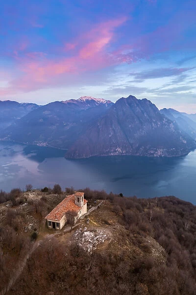 small church of San Defendente dominating Lake Iseo at sunset. Solto Collina, Iseo Lake, Bergamo district, Lombardy, Italy