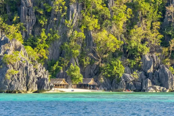 Framed Print : Small huts against dramatic karst cliffs on Coron Island, Palawan, Philippines Framed Print : Small huts against dramatic karst cliffs on Coron Island, Palawan, Philippines