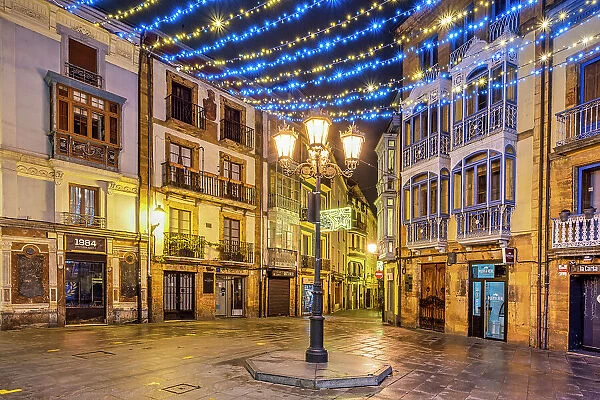 Small square adorned with Christmas lights in the old town, Oviedo, Asturias, Spain