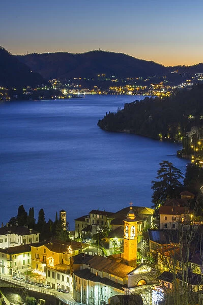 Small towns on the banks of Como lake at dusk. Como, Lombardy, Italy