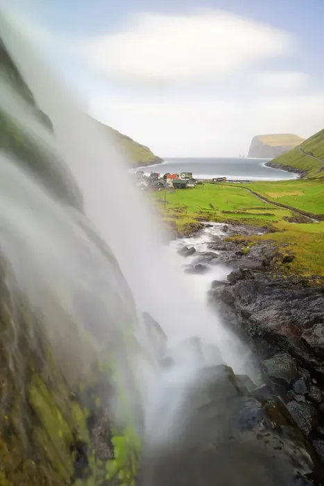 Framed Print : Small waterfall and Tjornuvik village, Sunda municipality, Streymoy, Faroe Islands, Denmark Framed Print : Small waterfall and Tjornuvik village, Sunda municipality, Streymoy, Faroe Islands, Denmark