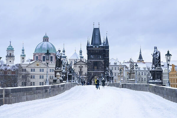 Snow-covered Charles Bridge and Old Town Bridge Tower in winter, Prague, Bohemia