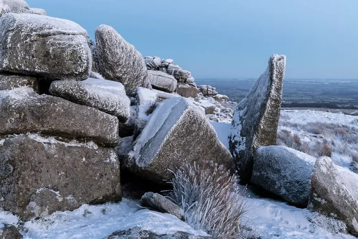 Framed Print : Snow covered granite outcrop at Belstone Tor in Dartmoor National Park, Devon, England. Winter (December) 2022