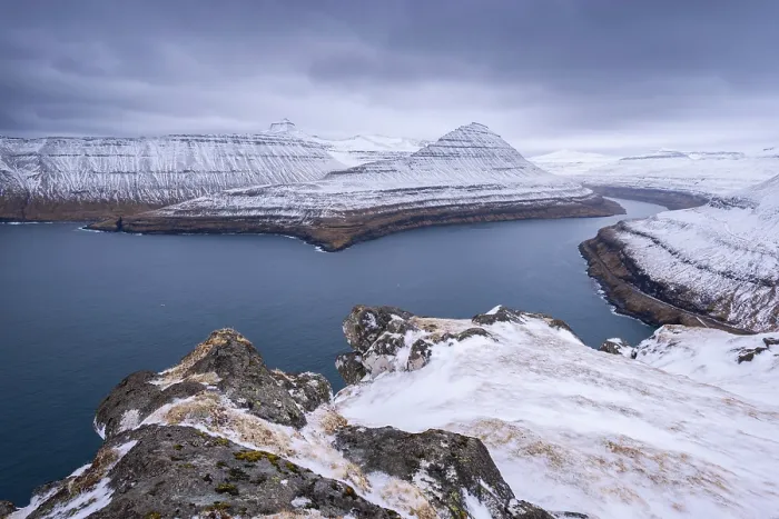 Framed Print : Snow covered mountains surround Funningsfjordur on the island of Eysturoy in the Faroe Islands Framed Print : Snow covered mountains surround Funningsfjordur on the island of Eysturoy in the Faroe Islands