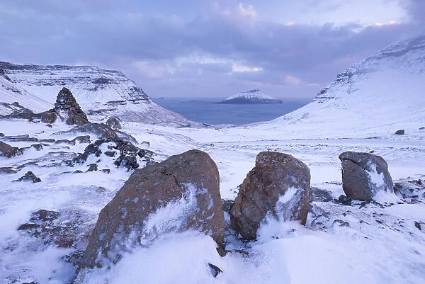 Snow covered Streymoy mountain landscape looking towards the island of Koltur, Faroe