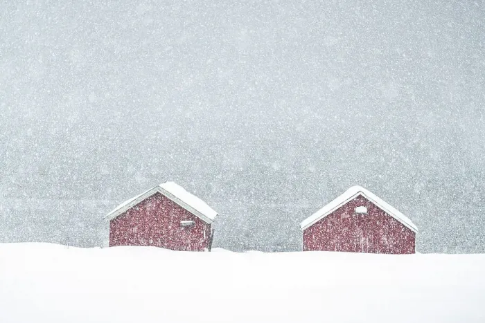 Framed Print : Snow storm over traditional red cabins by the sea, Troms county, Norway Framed Print : Snow storm over traditional red cabins by the sea, Troms county, Norway