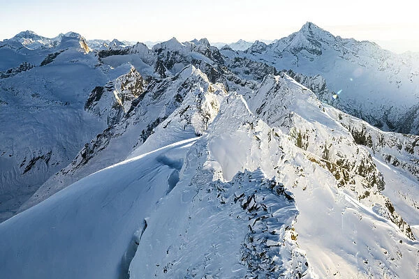 Snowcapped Cime della Bondasca mountains during a winter sunrise, aerial view, Val Bregaglia, Graubunden canton, Switzerland