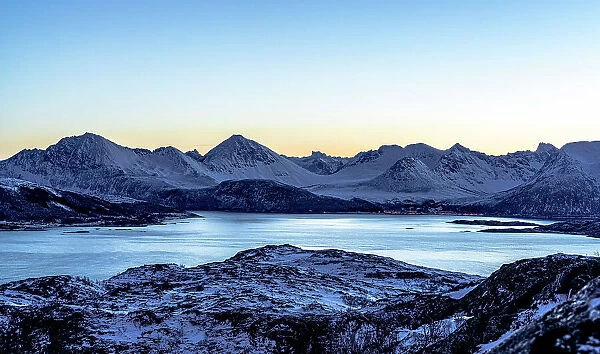 Snowcapped mountains and frozen sea at dusk, Sommaroy, Troms county, Norway