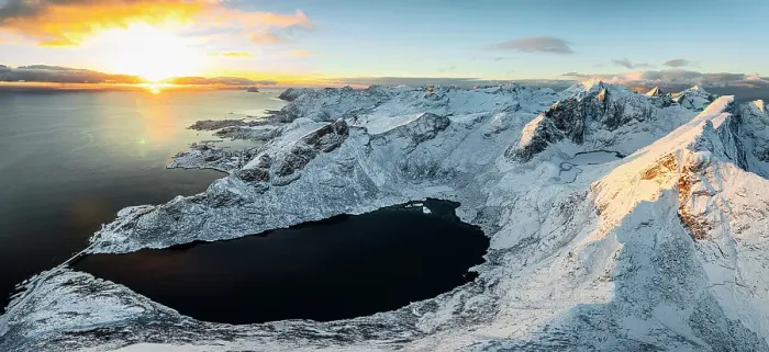 Framed Print : Snowcapped mountains and icy fjord lit by the warm arctic sunset in winter, Reine, Lofoten Islands, Norway Framed Print : Snowcapped mountains and icy fjord lit by the warm arctic sunset in winter, Reine, Lofoten Islands, Norway