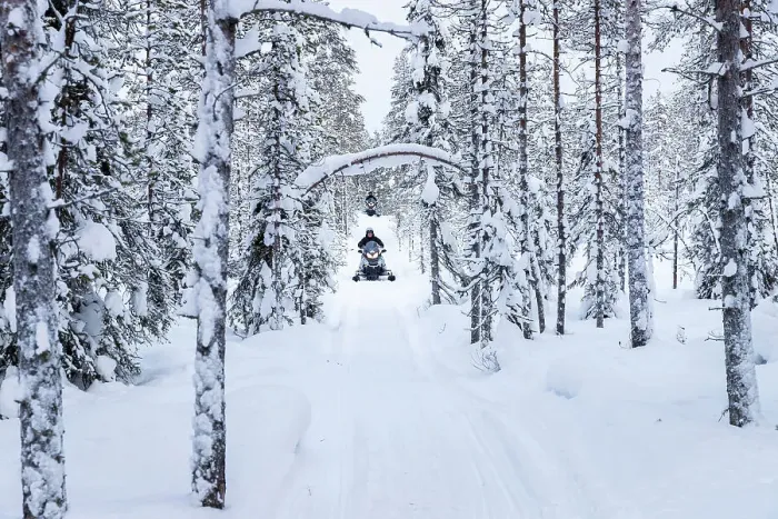 Framed Print : Snowmobiles on forest road, Kuusamo, Finland