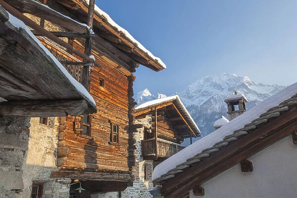 Snowy mountain huts framed by blue sky Soglio canton of Graub√ºnden Maloja District Bregaglia Valley Engadine Switzerland Europe
