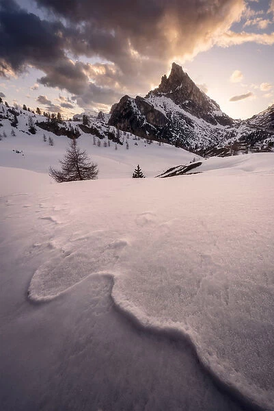 Snowy peaks of the Dolomites during a fiery sunset from the Falzarego Pass, Dolomites