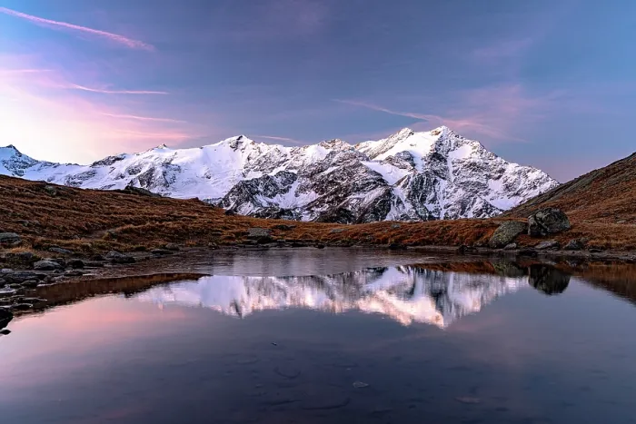 Framed Print : Snowy peaks reflected in water at dawn, Val Cedec, Valtellina, Lombardy, Italy