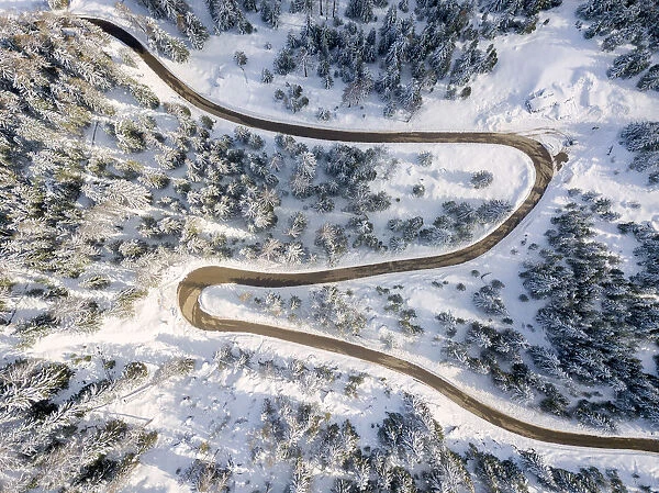 Snowy road aerial view, Passo Delle Erbe, Funes Valley, South Tyrol, Italy