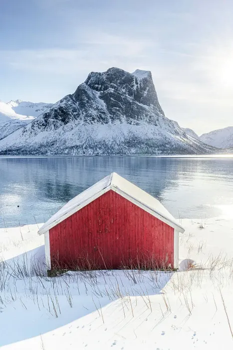 Framed Print : Snowy rorbu overlooking the frozen sea, Bergsfjorden, Senja, Troms county, Norway