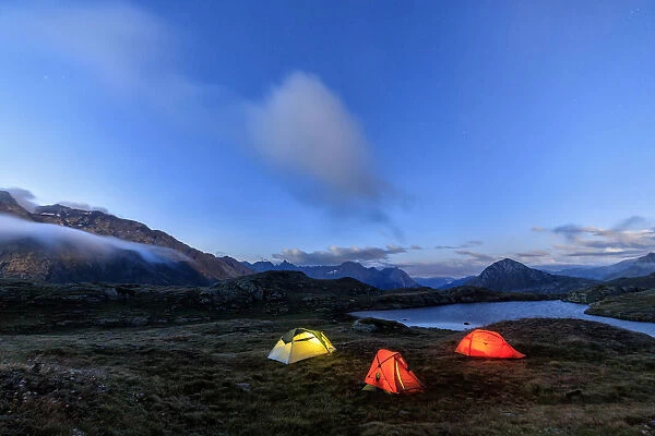 The soft lights of the tents light up dusk Minor Valley High Valtellina Livigno Lombardy