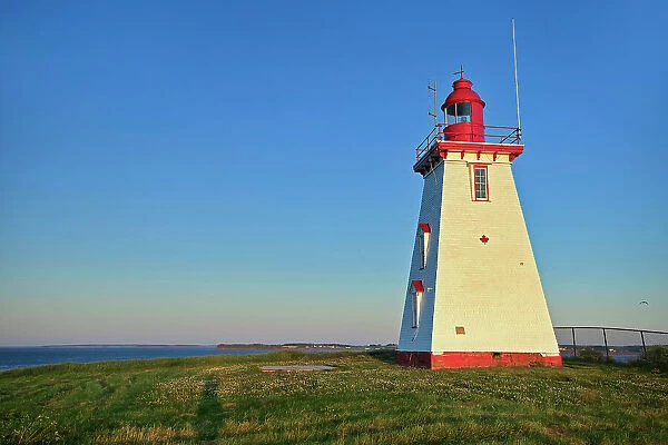 Souris East Lighthouse (historic) above the cliff on Knight Point. sunrise Souris, Prince Edward Island, Canada