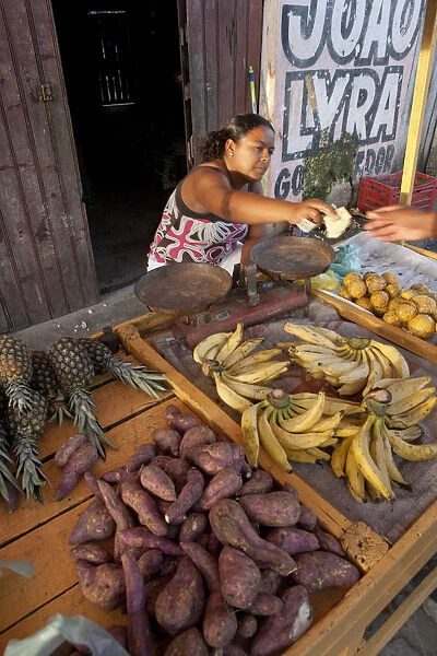 South America, Brazil, Alagoas, Maragogi, a woman selling fruit and vegetables in
