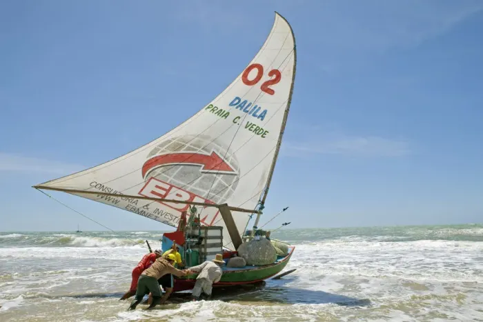 Framed Print : South America, Brazil, Ceara, Fortaleza, fishermen launching a jangada on the beach