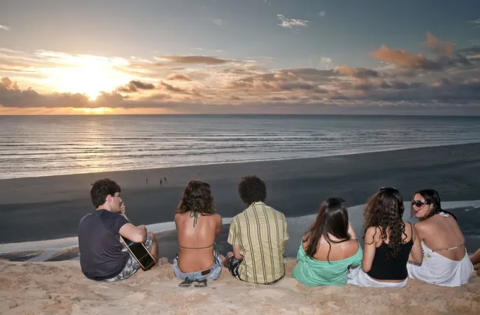Framed Print : South America, Brazil, Ceara, Jericoacoara, a guitarist and a group of girls watch Framed Print : South America, Brazil, Ceara, Jericoacoara, a guitarist and a group of girls watch