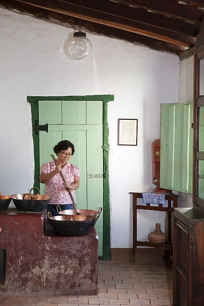 South America, Brazil, Goias, Cidade de Goias, A woman stirring a traditional copper