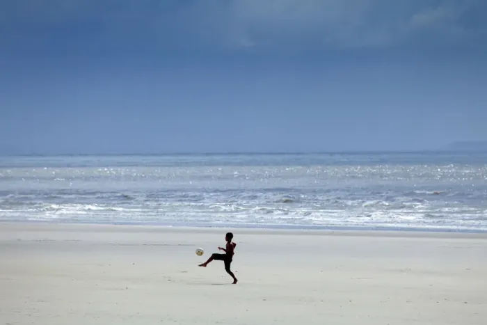 Framed Print : South America, Brazil, Maranhao, Sao Luis, Sao Marcos beach, boy playing football