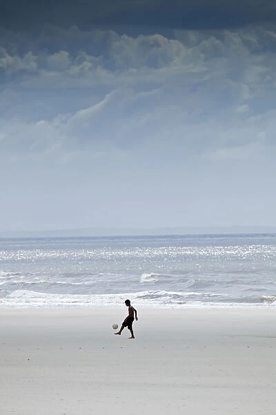 South America, Brazil, Maranhao, Sao Luis, Sao Marcos beach, boy playing football