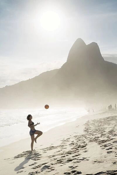 South America, Brazil, Rio de Janeiro, a woman practising football or altinha on Ipanema beach
