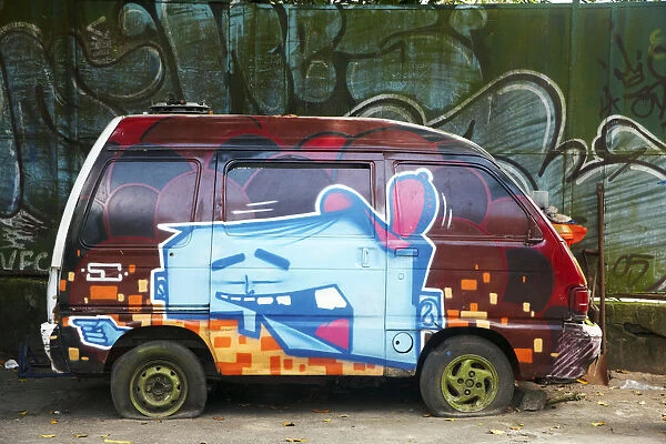 South America, Brazil, Rio de Janeiro, graffiti daubed on the side of an abandoned