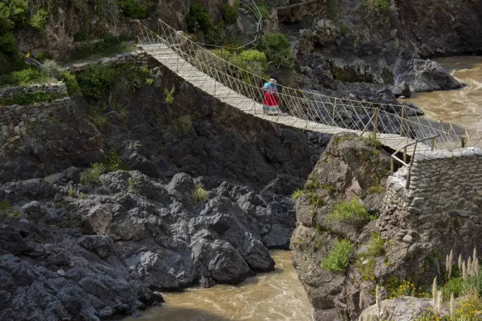 Framed Print : South America, Peru, Colca Canyon, native woman walking over inca bridge Framed Print : South America, Peru, Colca Canyon, native woman walking over inca bridge