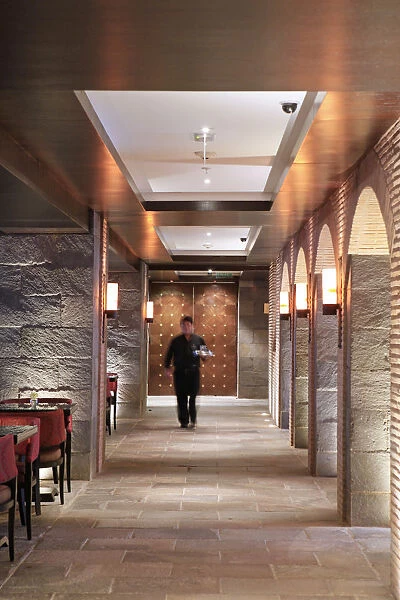 South America, Peru, Cusco, Marriott hotel, a waiter walking along a corridor in the