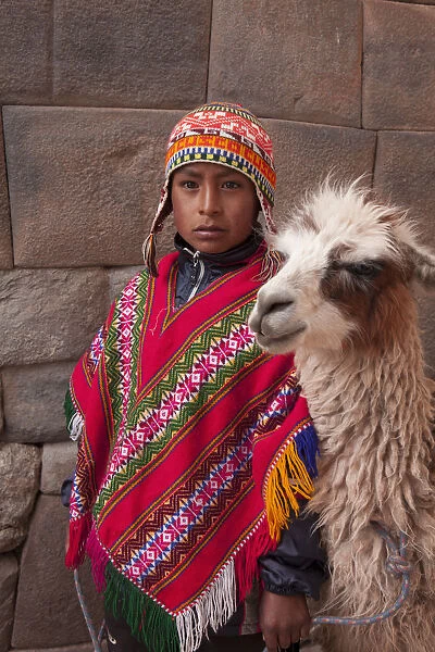 South America, Peru, Cusco. A Quechua boy in a poncho and a chullo woollen cap with