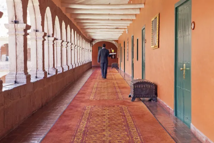 Framed Print : South America, Peru, Cusco, a waiter carrying a tray with a cocktail to a room in Framed Print : South America, Peru, Cusco, a waiter carrying a tray with a cocktail to a room in