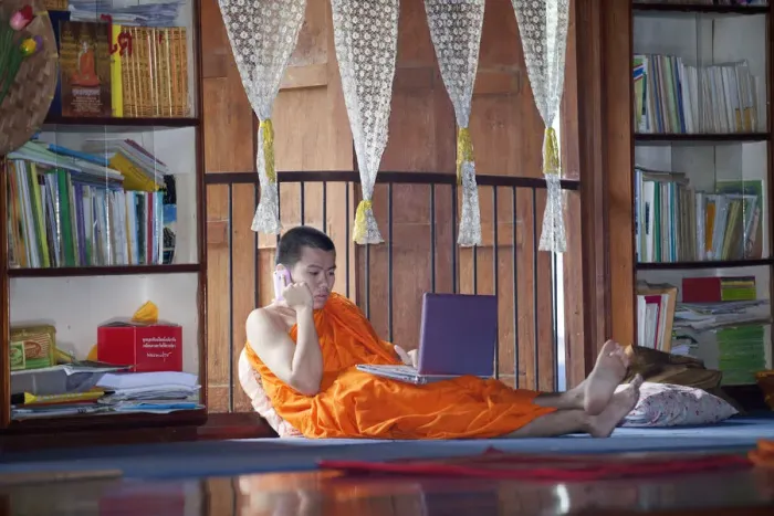 Framed Print : South East Asia, Thailand, Buddhist monk using a lap top and a mobile phone Framed Print : South East Asia, Thailand, Buddhist monk using a lap top and a mobile phone