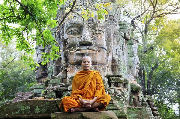 Southeast Asia, Cambodia, Siem Reap, Angkor temples, Buddhist monk in saffron robes meditating
