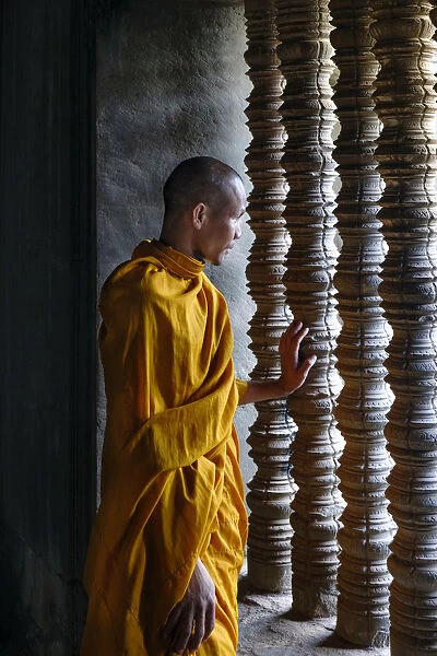 Southeast Asia, Cambodia, Siem Reap, Angkor temples, Buddhist monk looking out of