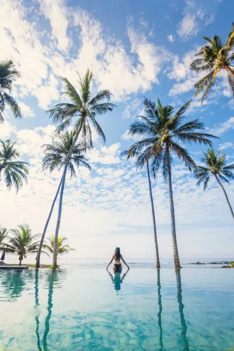 Framed Print : Southeast Asia, Indonesia, Bali, Candidasa. A woman looking out over the ocean from an Framed Print : Southeast Asia, Indonesia, Bali, Candidasa. A woman looking out over the ocean from an