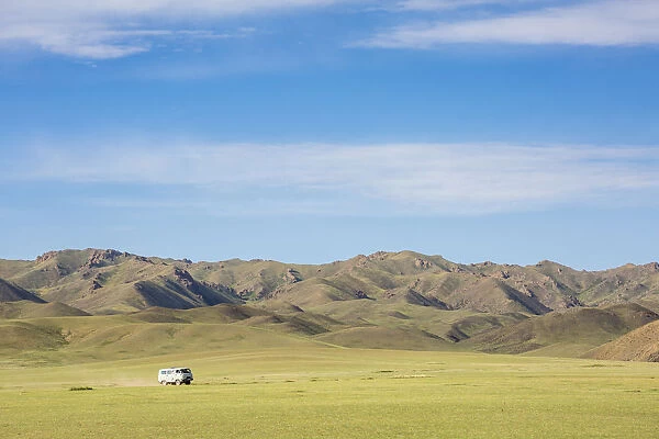 Soviet minivan and mountains in the background. Bayandalai district, South Gobi province