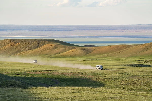 Two soviet vehicles driving on dirt roads. Bayandalai district, South Gobi province