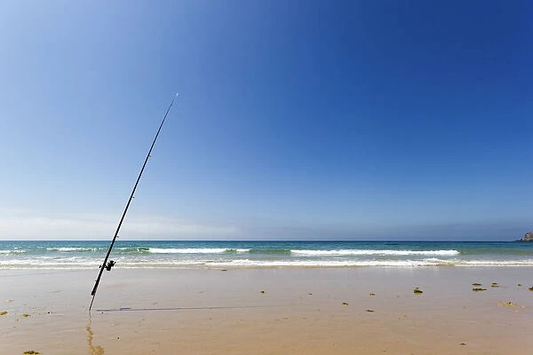 Spain, Bolonia, Tarifa. Lonely and isolated fishing rod on the shore of the beach