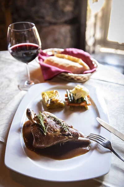 Spain, Canary Islands, Fuerteventura, Betancuria, A plate of roasted goat with rosemary sauce and potatoes mille-feuille