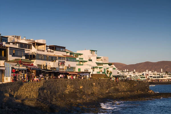 Spain, Canary Islands, Lanzarote, Playa Blanco, seafront view, dusk