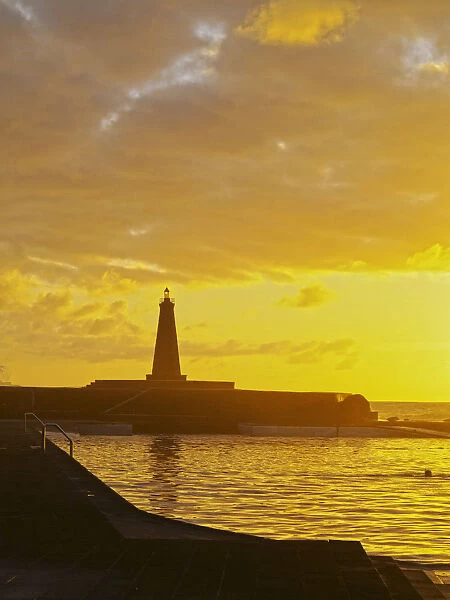 Spain, Canary Islands, Tenerife, Bajamar, Swimming pool and lighthouse during the sunset