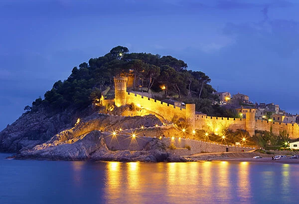 Spain, Catalonia, Costa Brava, Tossa de Mar, Overview of bay and castle at dusk