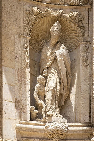 Spain, Comunidad Valenciana, Valencia, Sculpture of a bishop in the main faazade of